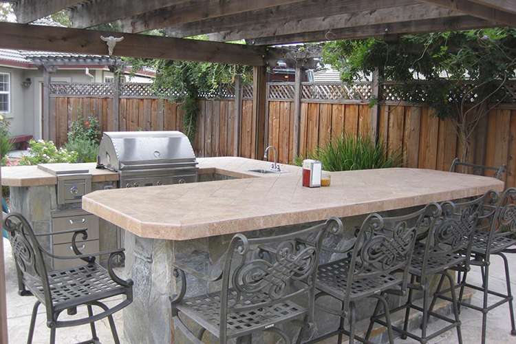 backyard kitchen and table J&S Landscape Boulder
